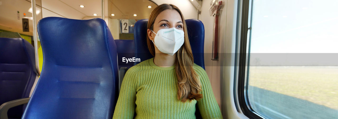 Banner of beautiful woman traveling on public transport wearing protective medical mask. 