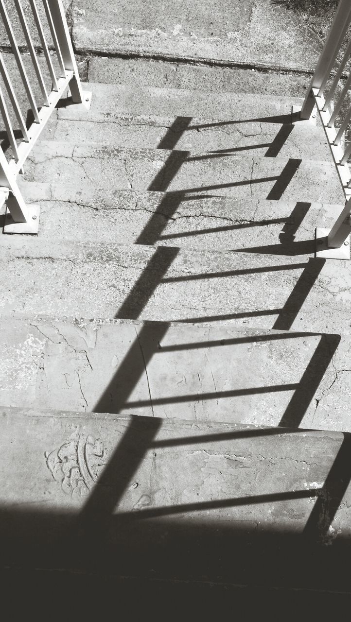 SHADOW OF RAILING ON STAIRCASE