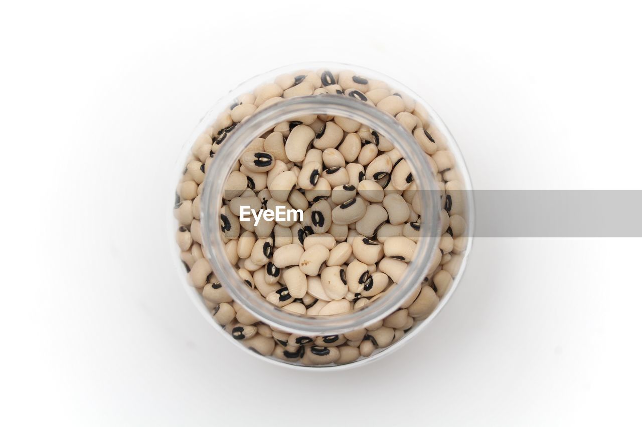 Black eyed peas in a jar on white background