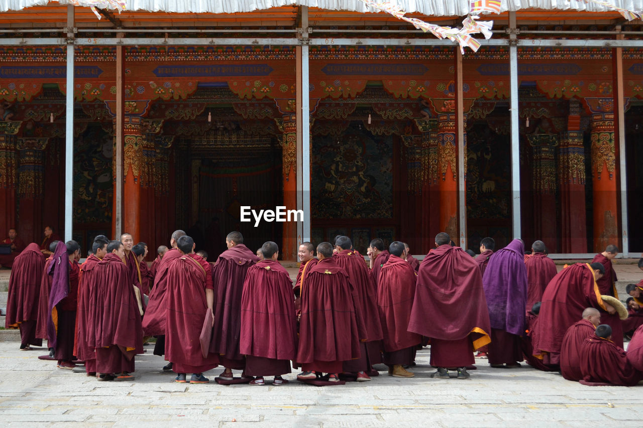 Group of monks standing outside temple