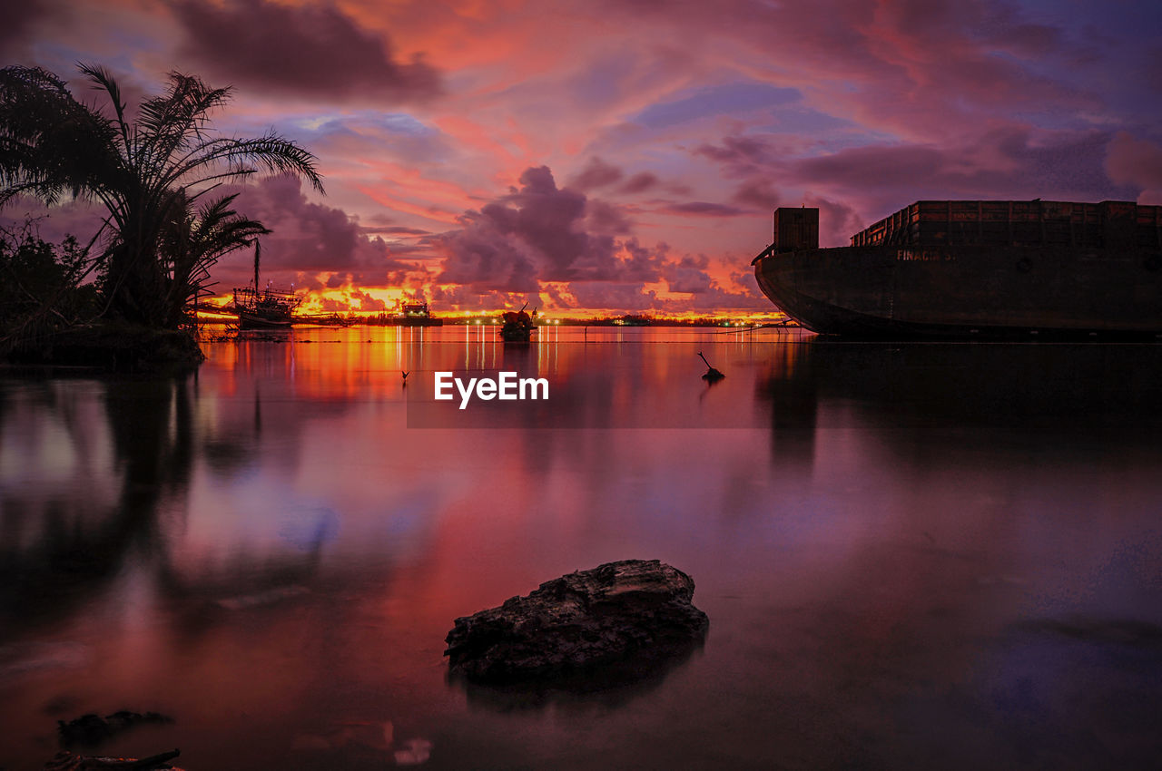 SCENIC VIEW OF ROCKS AT SUNSET