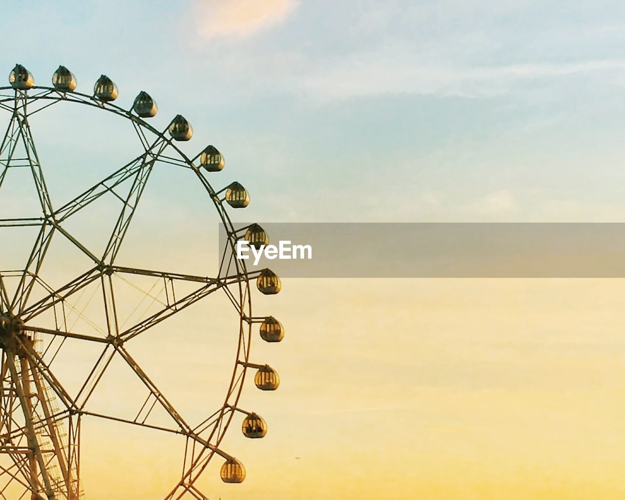 Low angle view of ferris wheel against sky