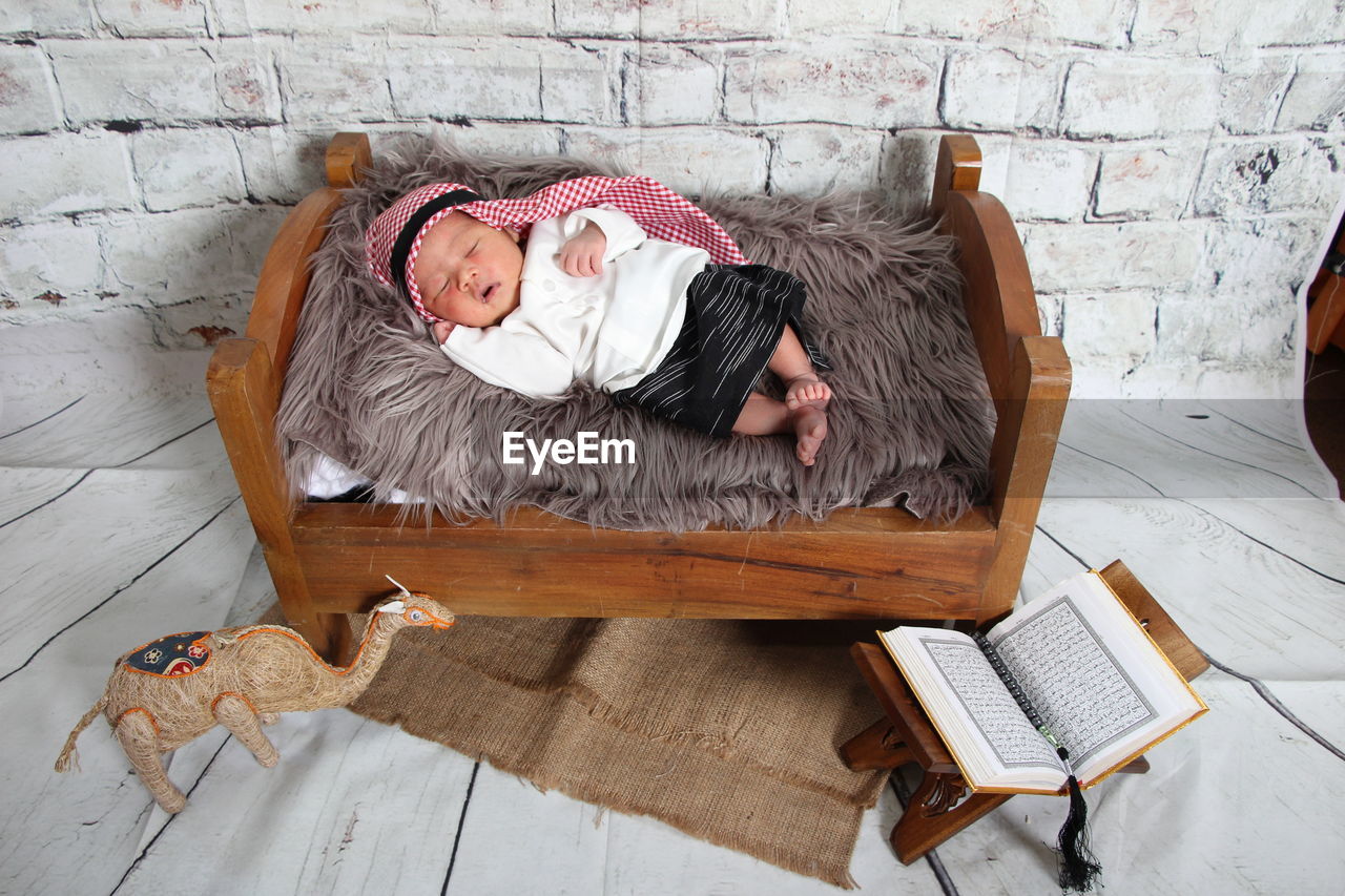 High angle view of baby sleeping in bed
