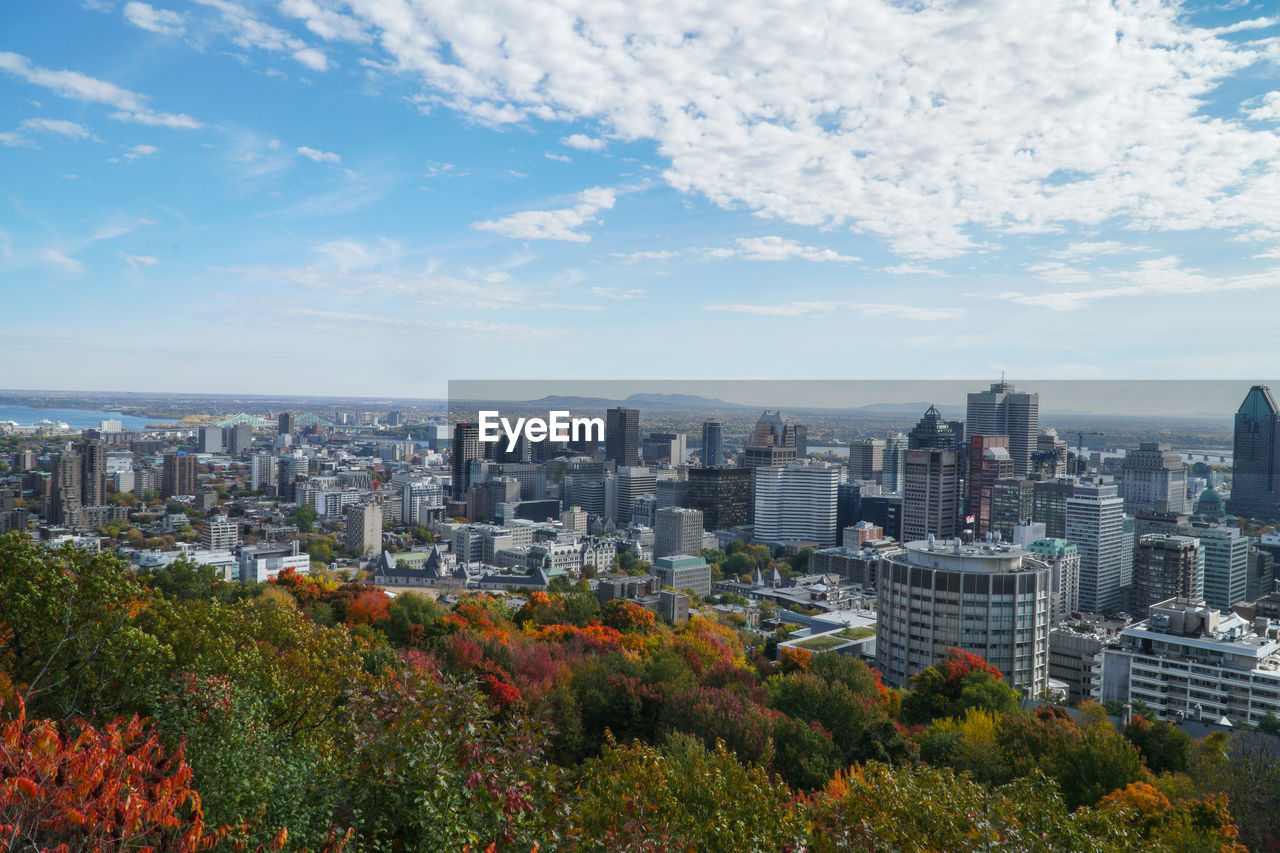 View of cityscape against cloudy sky