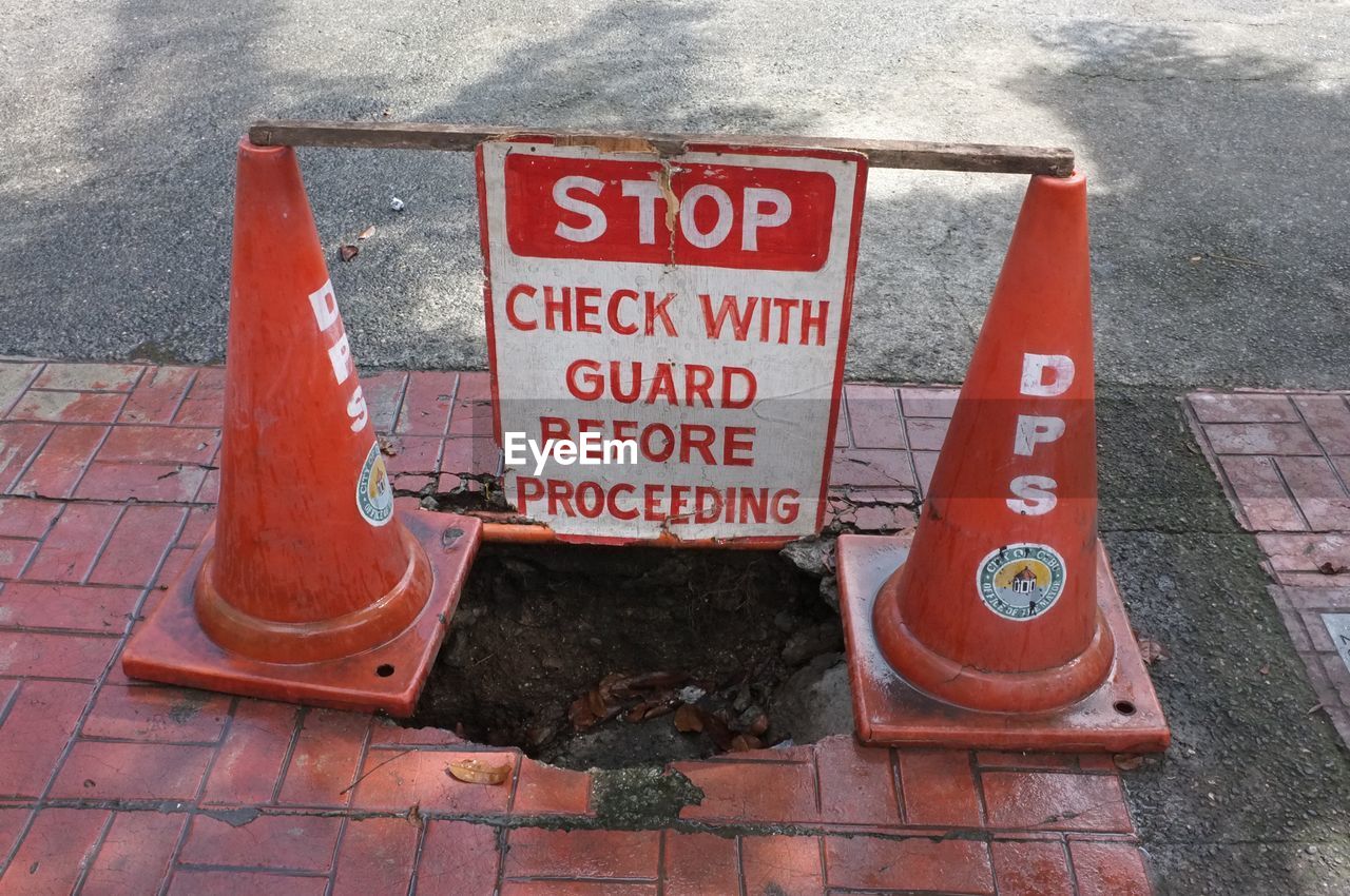 TEXT ON RED SIGNBOARD AGAINST WALL