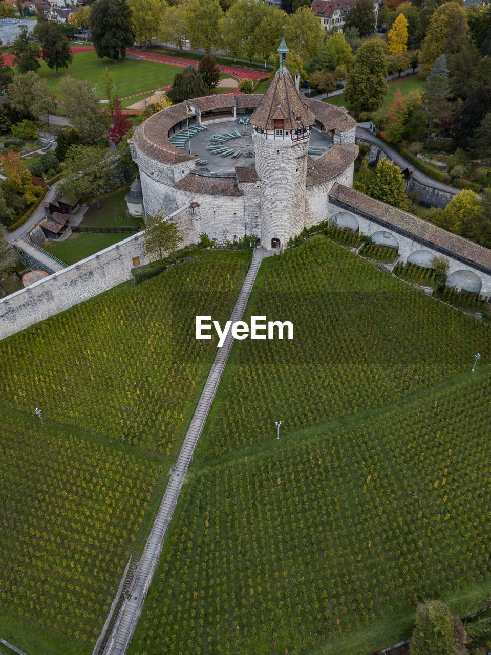 HIGH ANGLE VIEW OF BUILT STRUCTURE AND TREES