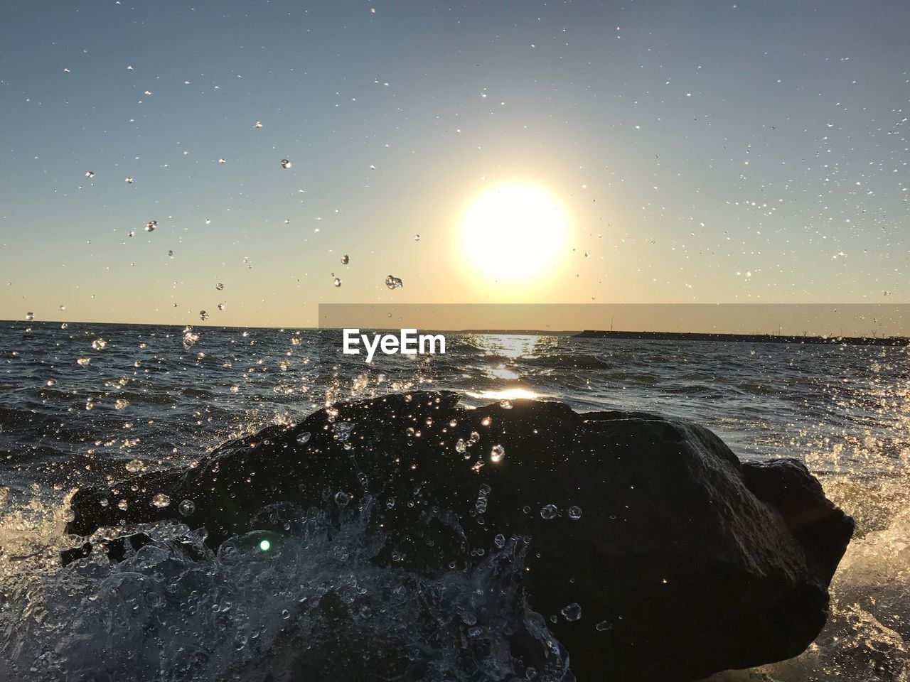 CLOSE-UP OF SEA AGAINST SKY DURING SUNSET