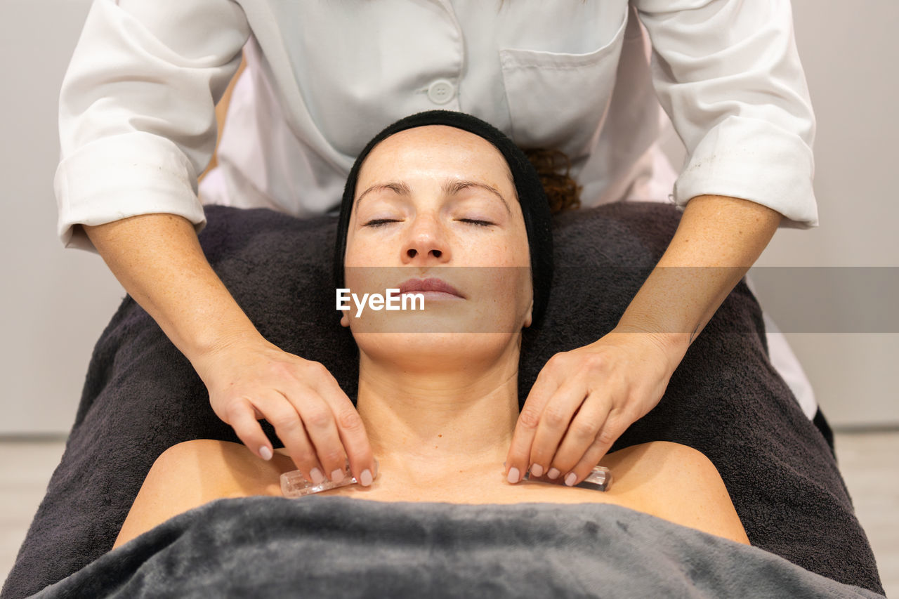 midsection of man lying on bed at home