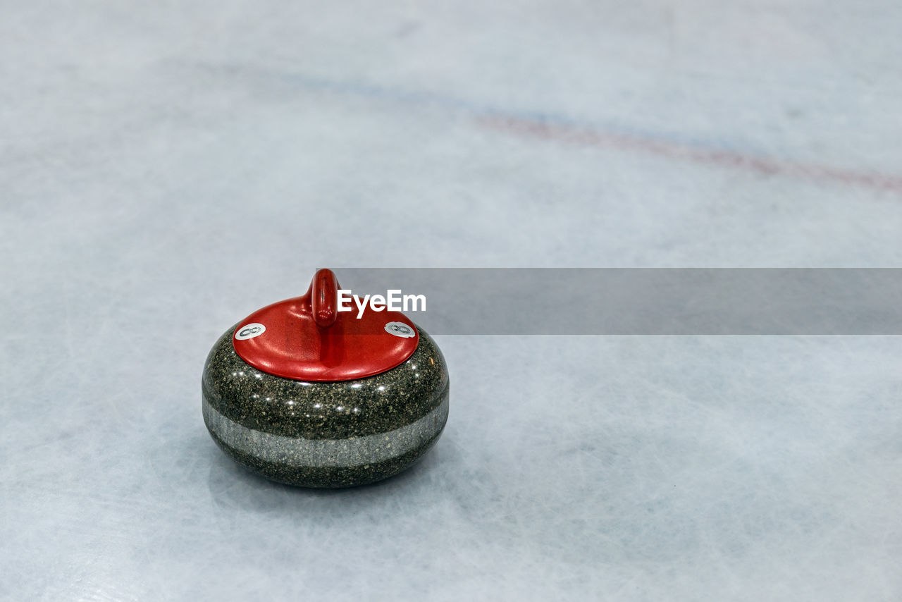 Close-up of curling stone on ice rink