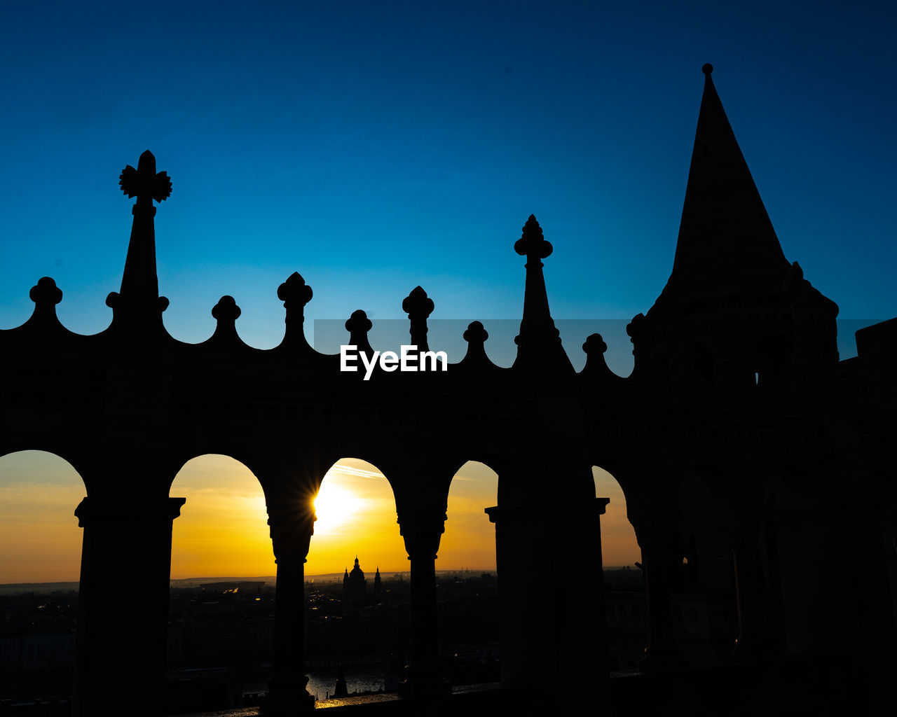 Low angle view of silhouette building against sky during sunset