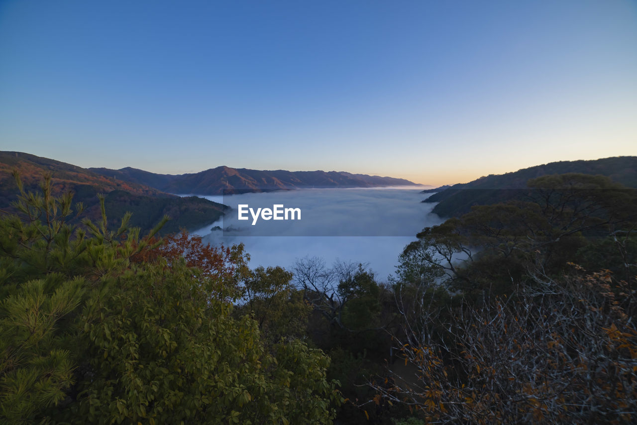 scenic view of lake and mountains against clear sky