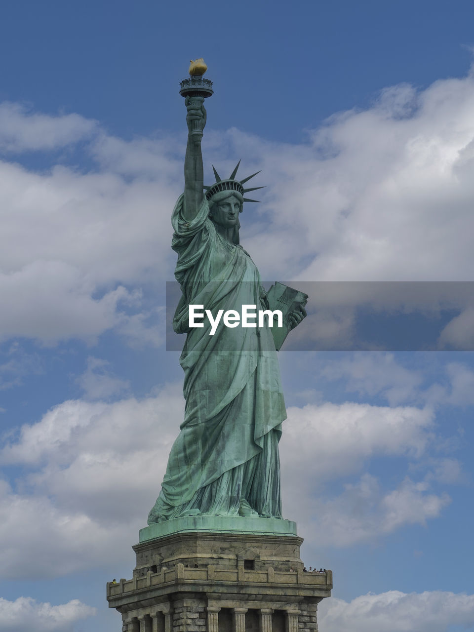 Low angle view of statue against cloudy sky