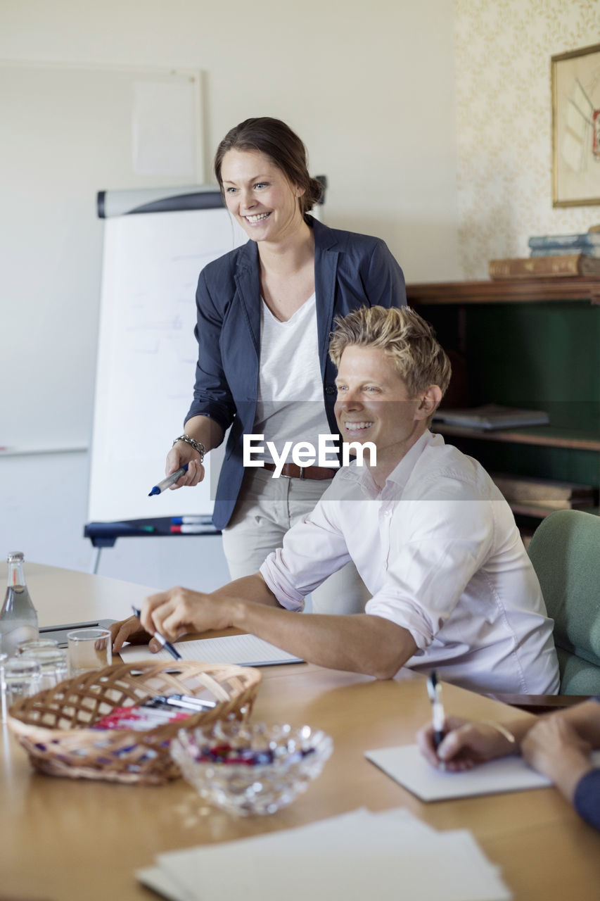 Happy business people in board room