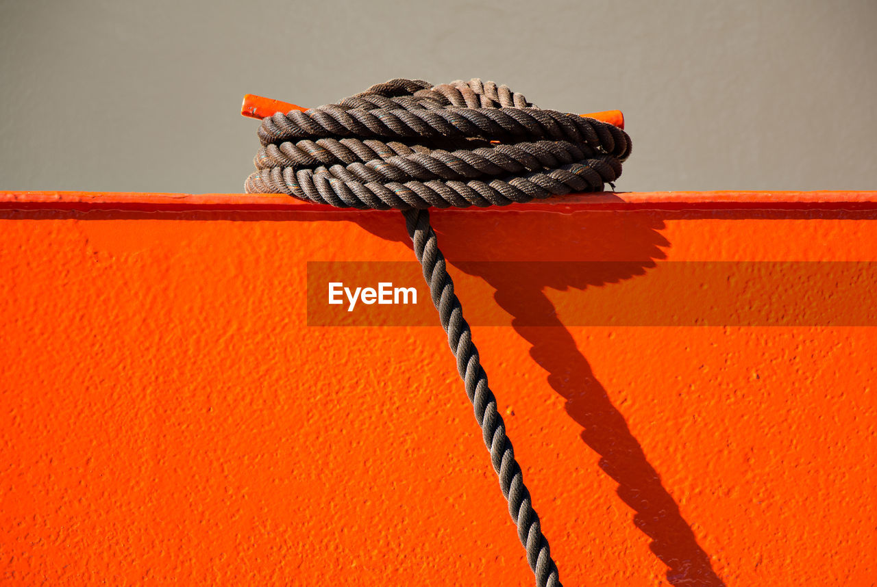 Close-up of rope on orange metal