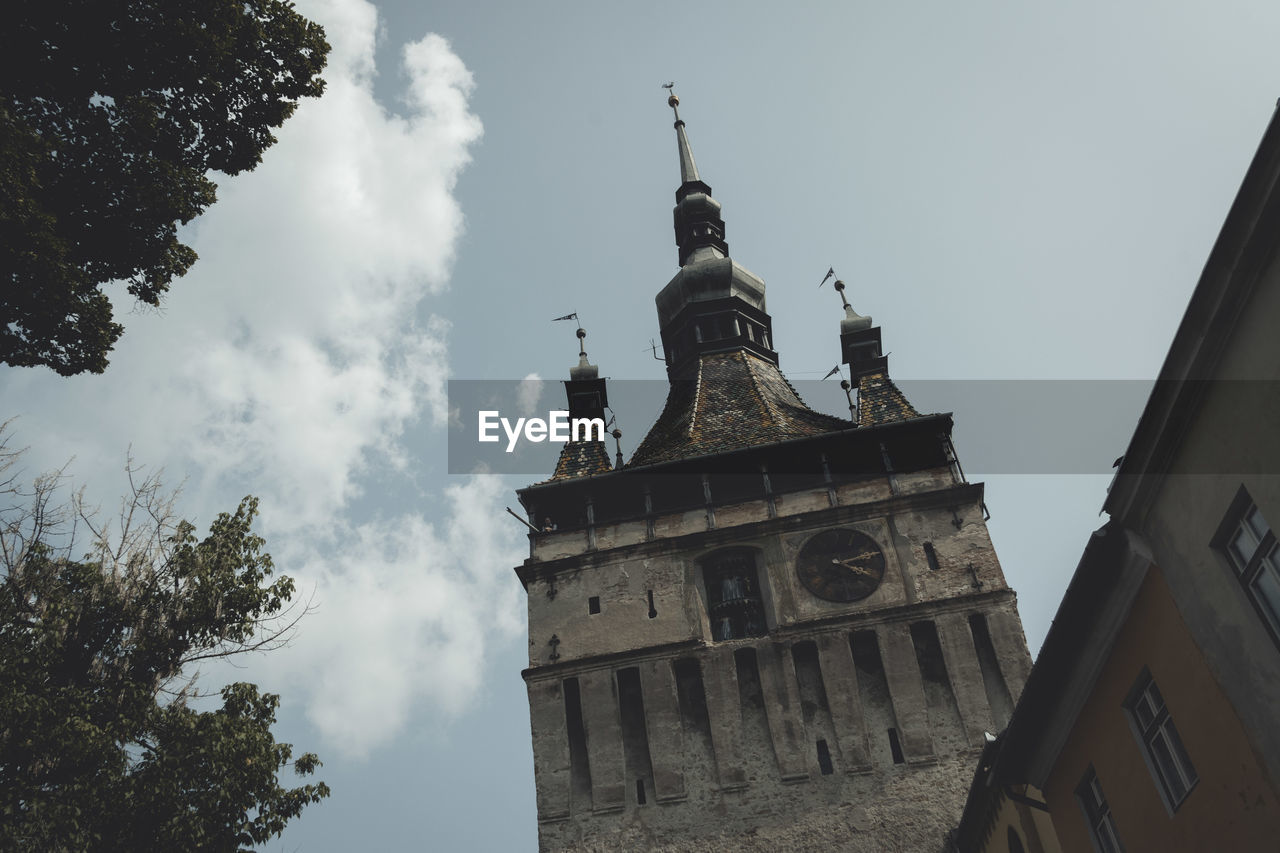 Low angle view of bell tower against sky