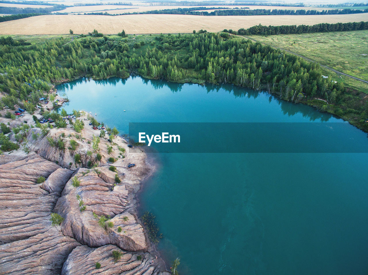 SCENIC VIEW OF LAKE BY AGRICULTURAL FIELD