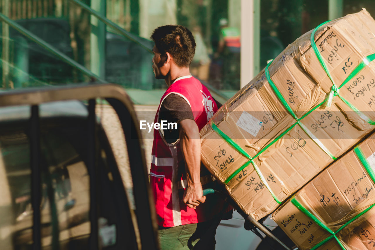 REAR VIEW OF WOMAN WITH TEXT ON BOX