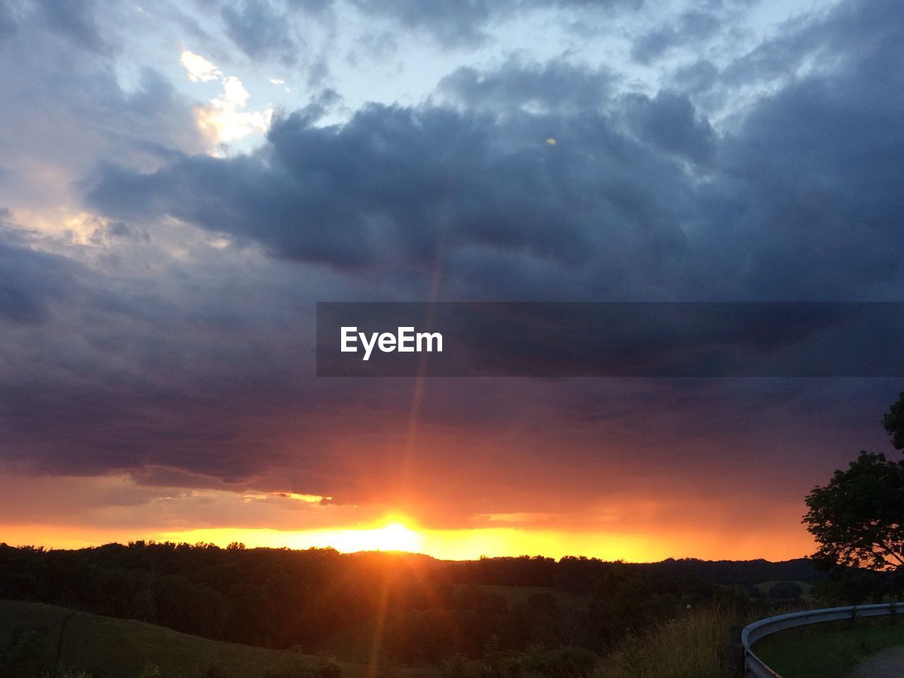 SILHOUETTE LANDSCAPE AGAINST SUNSET SKY