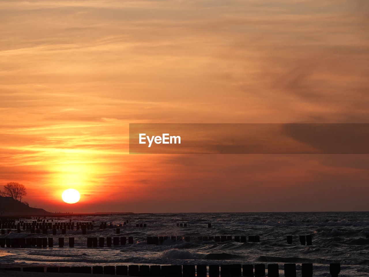 Scenic view of sea against romantic sky at sunset