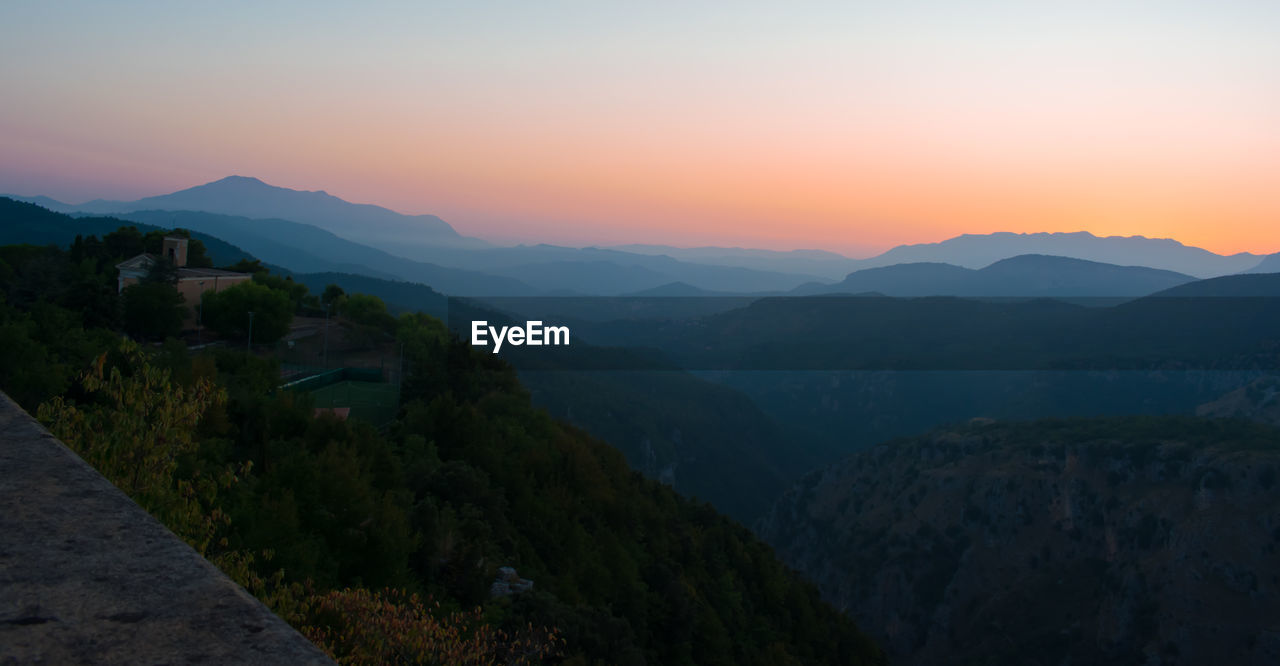 Scenic view of mountains against sky during sunset