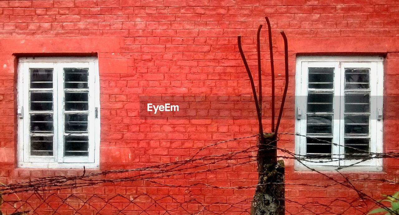 Fence against red building