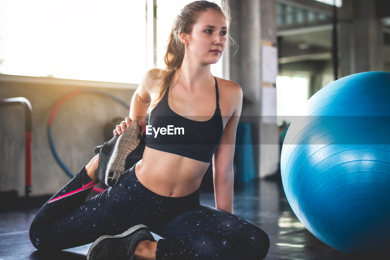 Young woman exercising at home