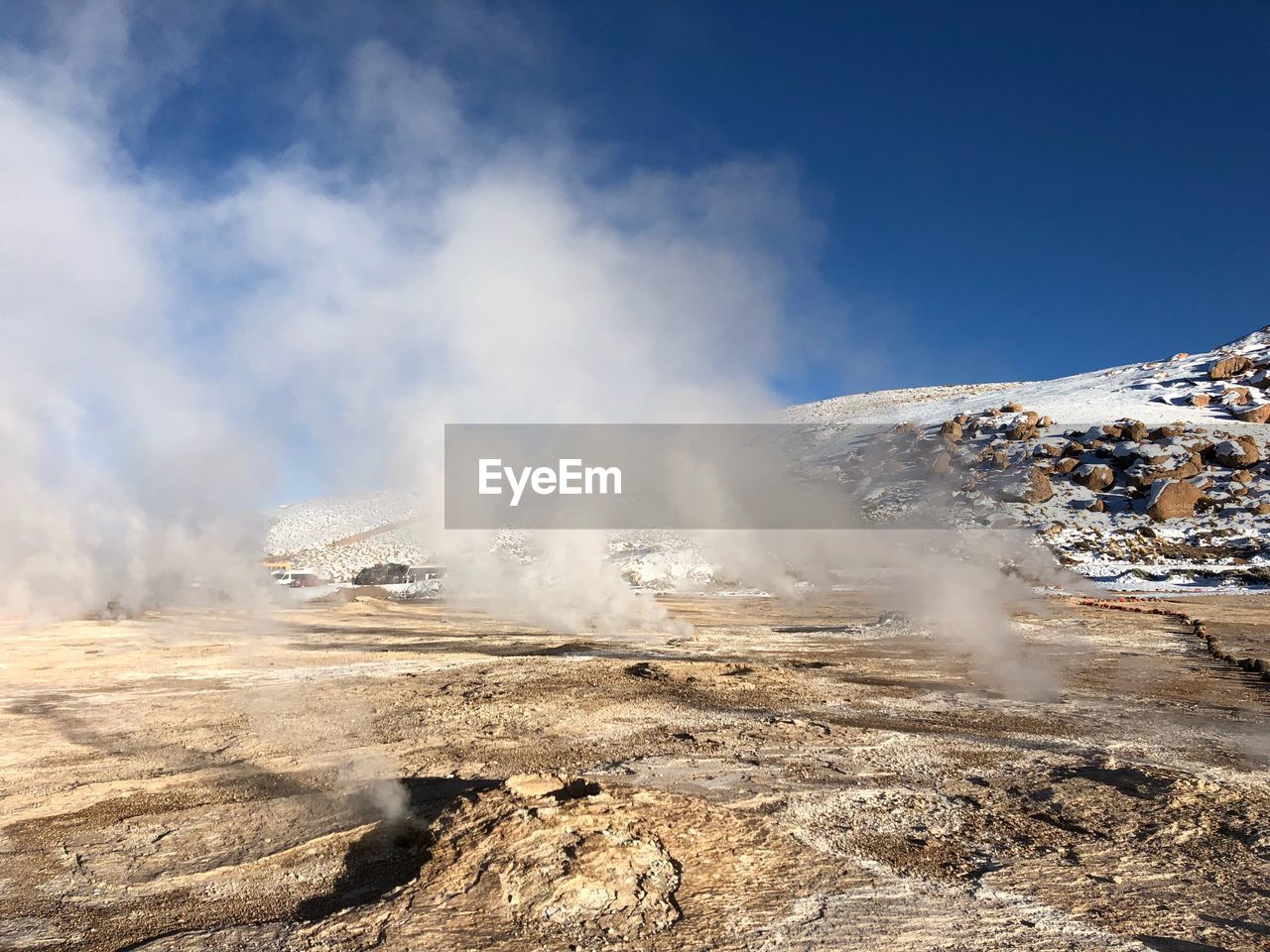 Smoke emitting from volcanic mountain against sky