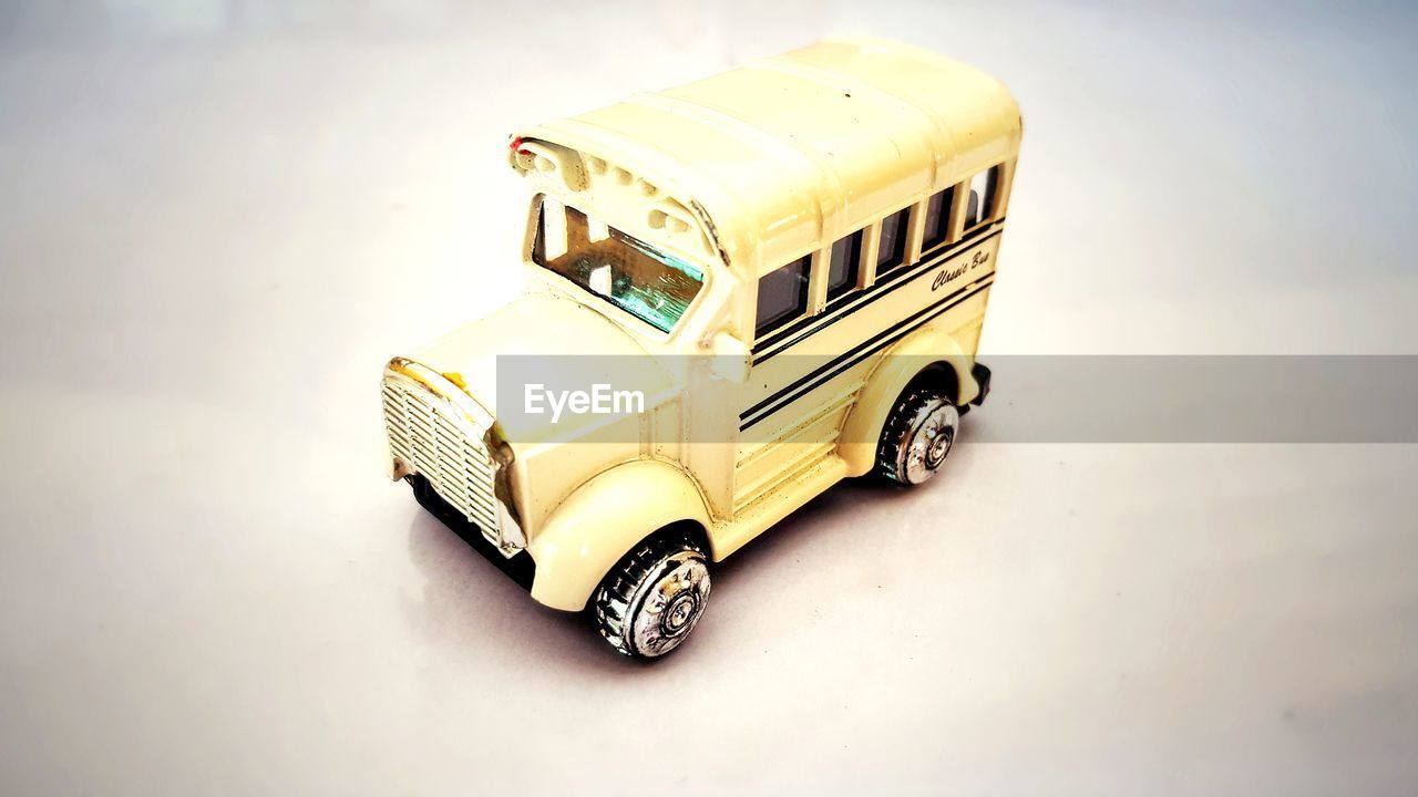 HIGH ANGLE VIEW OF TOY CAR ON WHITE BACKGROUND