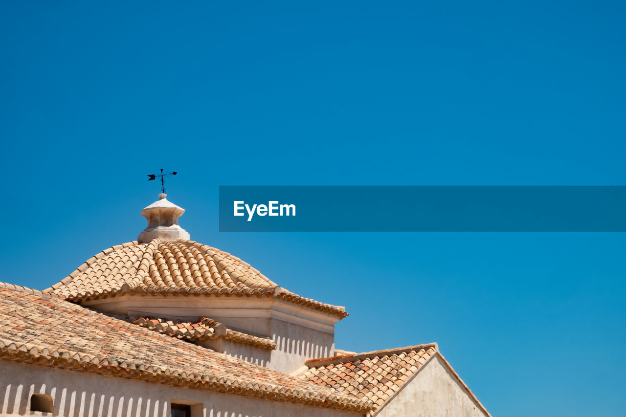 Low angle view of building against blue sky