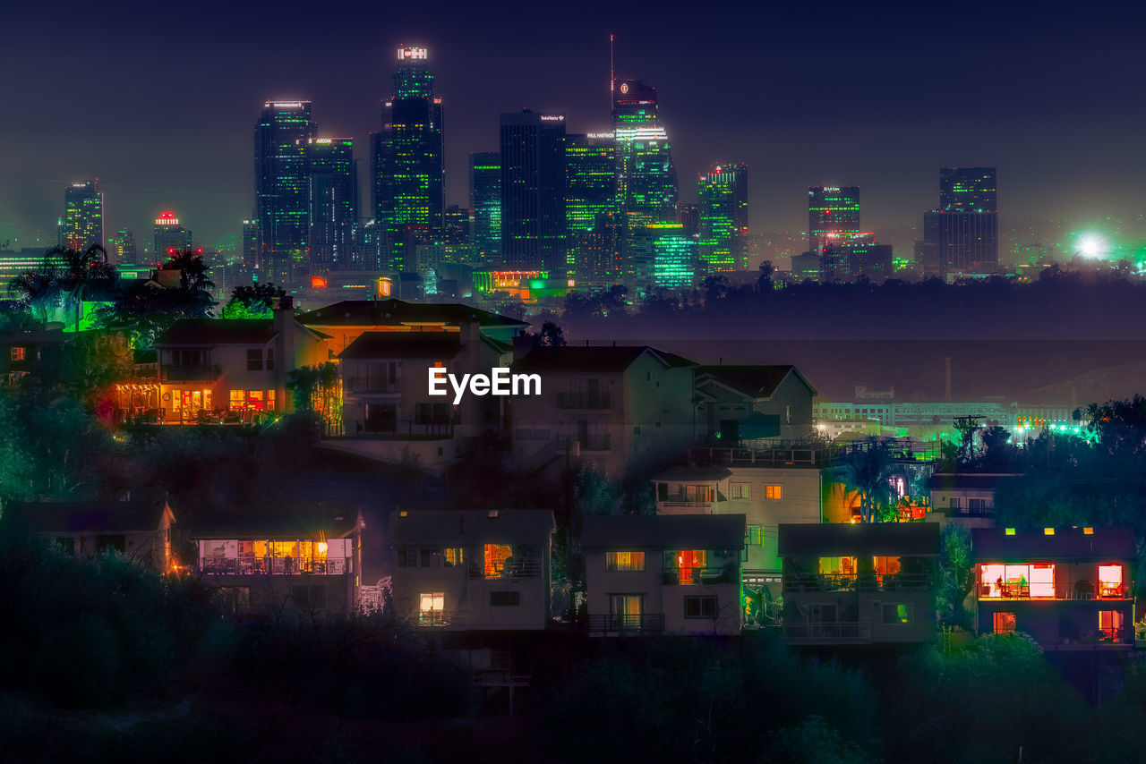 HIGH ANGLE VIEW OF ILLUMINATED BUILDINGS AGAINST SKY