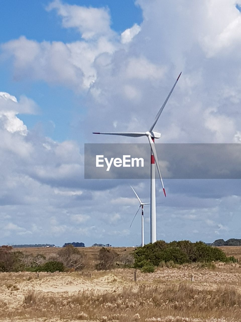 TRADITIONAL WINDMILL ON FIELD AGAINST SKY