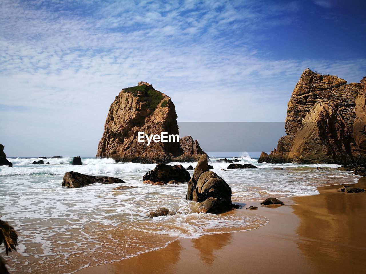 Rock formations on shore at beach