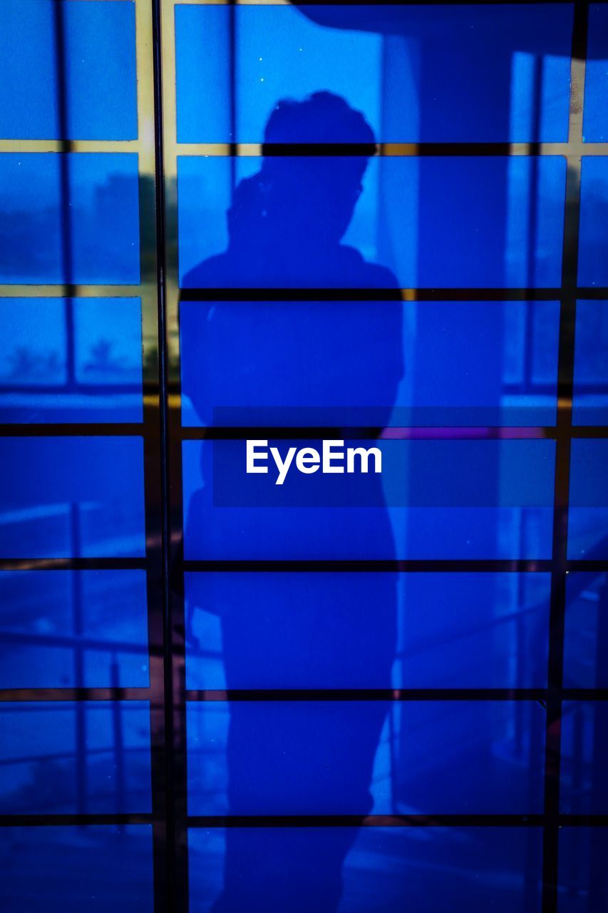 FULL FRAME SHOT OF GLASS WITH TILED FLOOR IN BACKGROUND