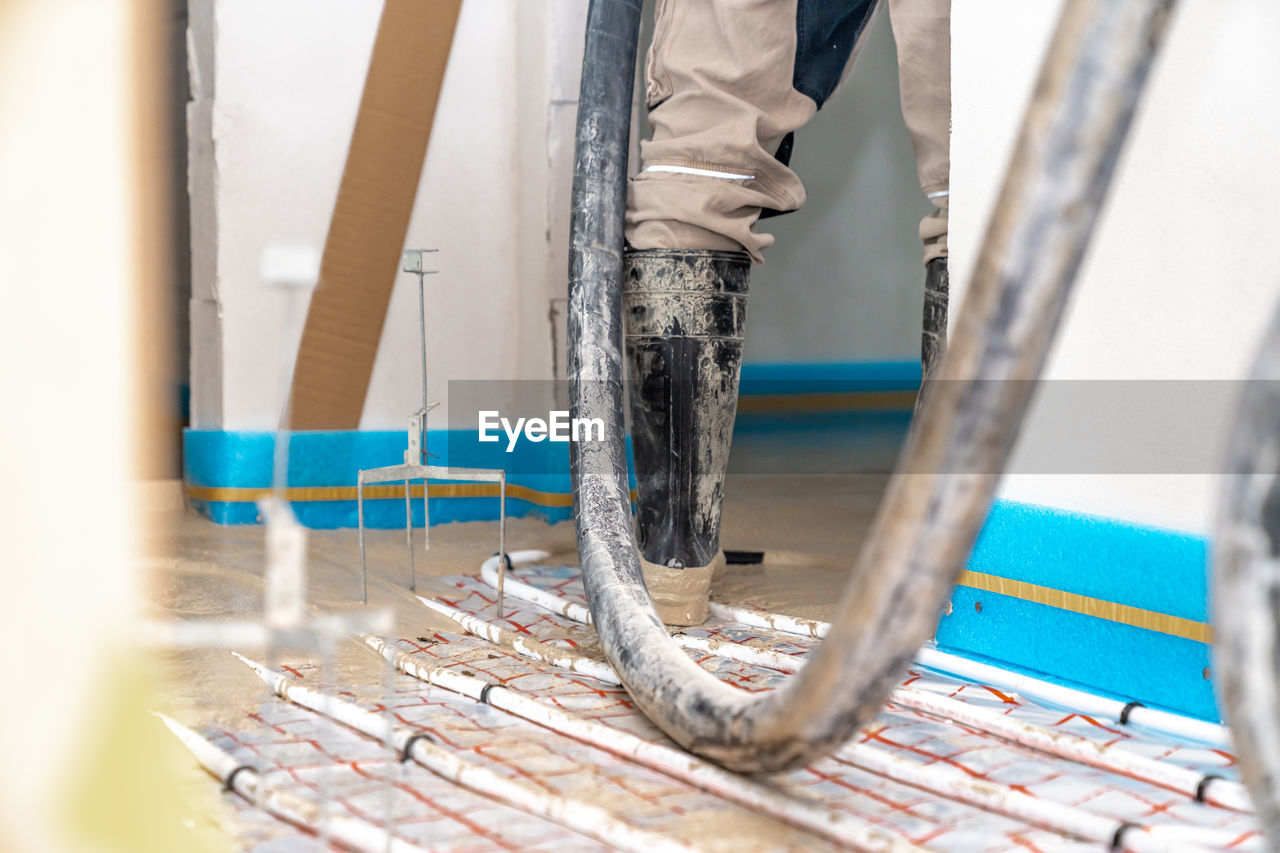 blue, one person, low section, occupation, spring, adult, working, indoors, industry, day, selective focus, construction industry, men, human leg, clothing, wood, construction site, art, standing