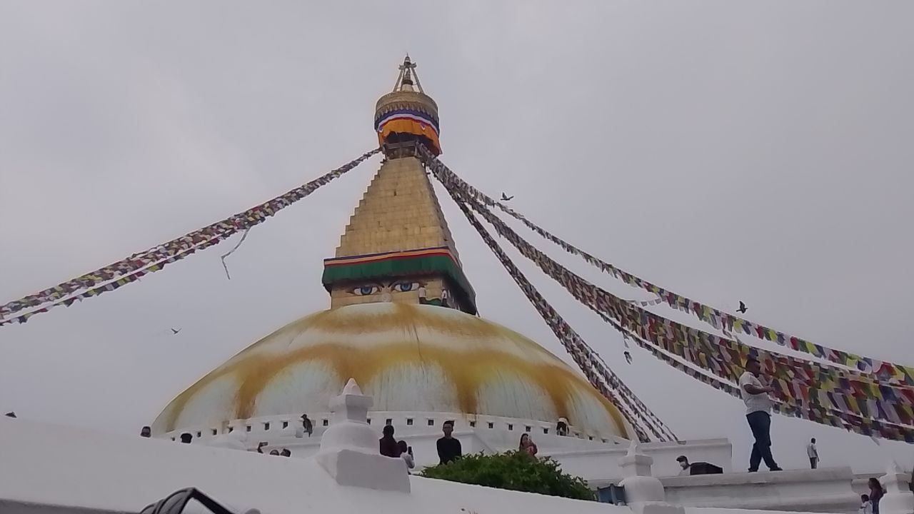 architecture, built structure, religion, travel destinations, place of worship, belief, travel, temple - building, building exterior, building, tourism, spirituality, history, nature, sky, environment, the past, landmark, city, tradition, tower, praying, outdoors, pagoda, ancient, gold, landscape, beauty in nature, temple, flag, scenics - nature