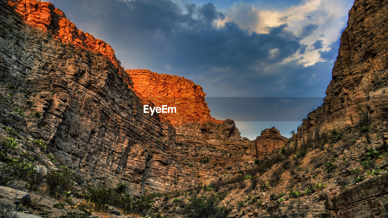 LOW ANGLE VIEW OF ROCK FORMATION AGAINST SKY