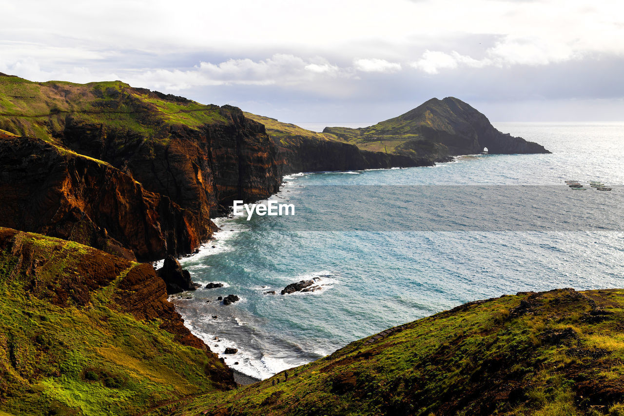 scenic view of sea and mountain against sky