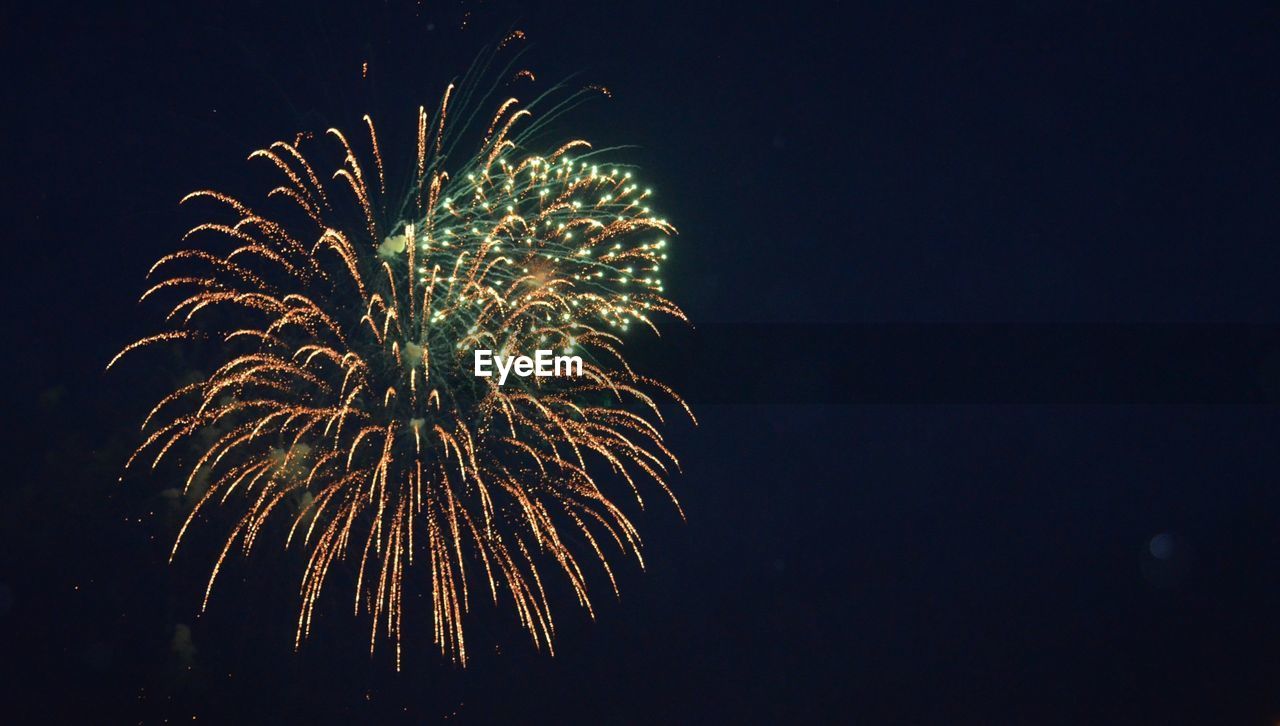 LOW ANGLE VIEW OF FIREWORKS IN SKY