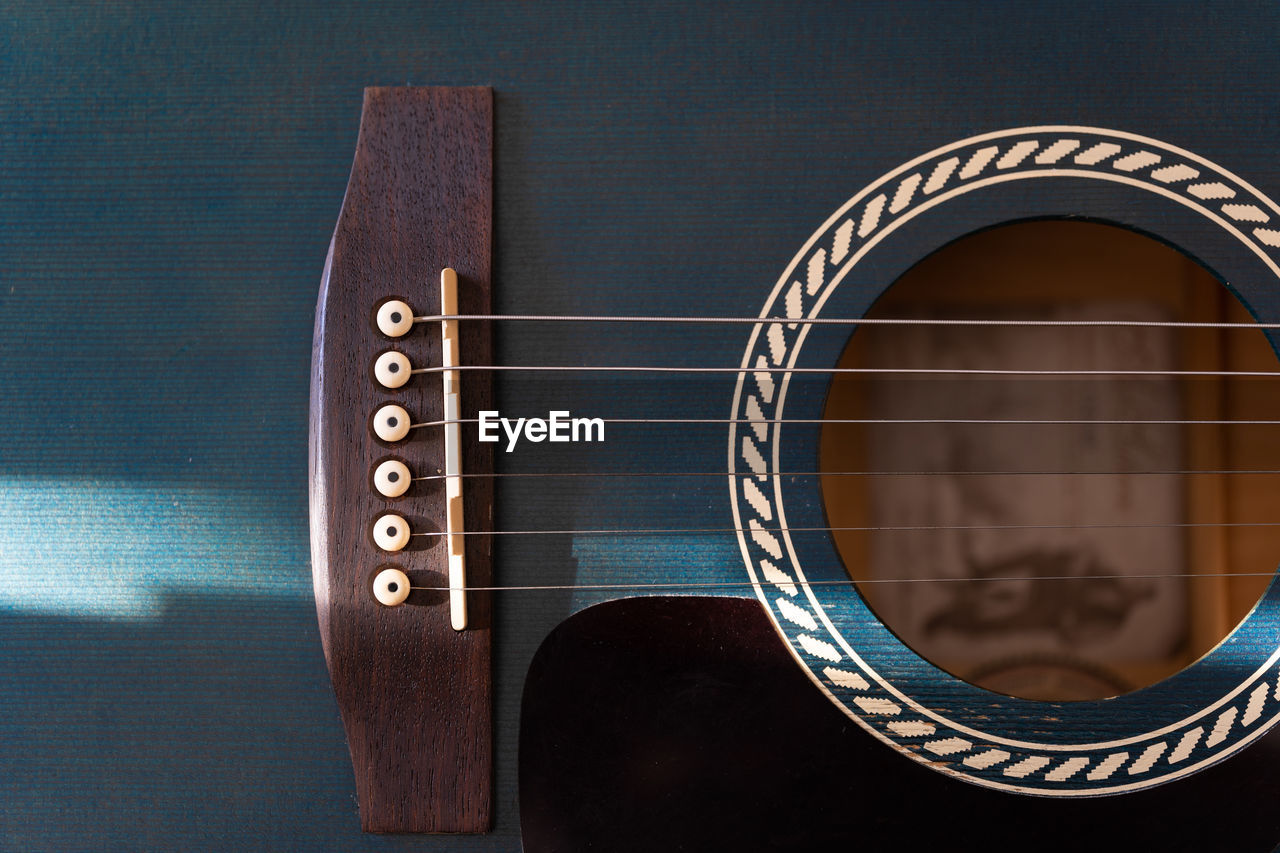 CLOSE-UP OF GUITAR IN THE DARK