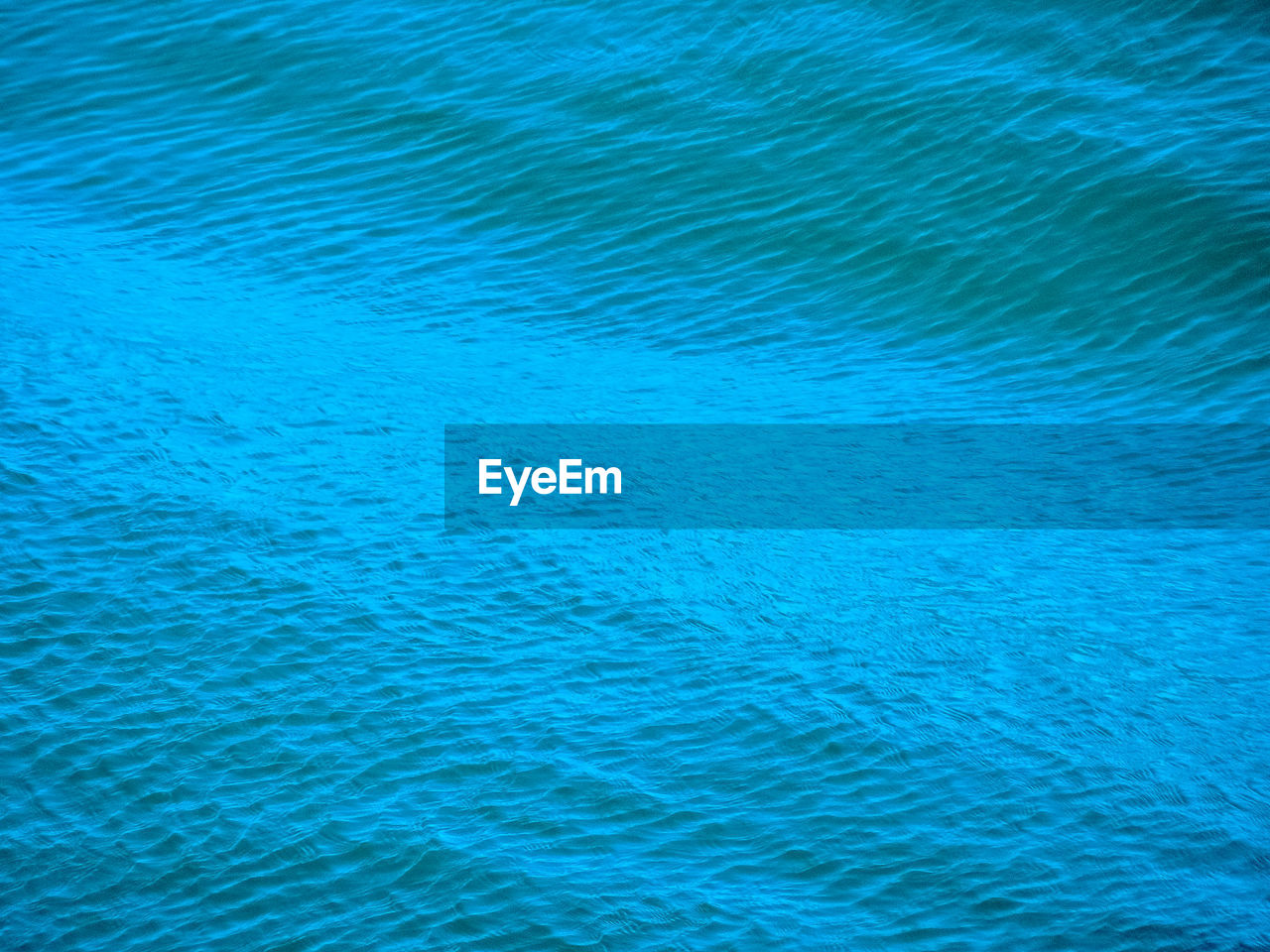 CLOSE-UP OF RIPPLED BLUE WATER