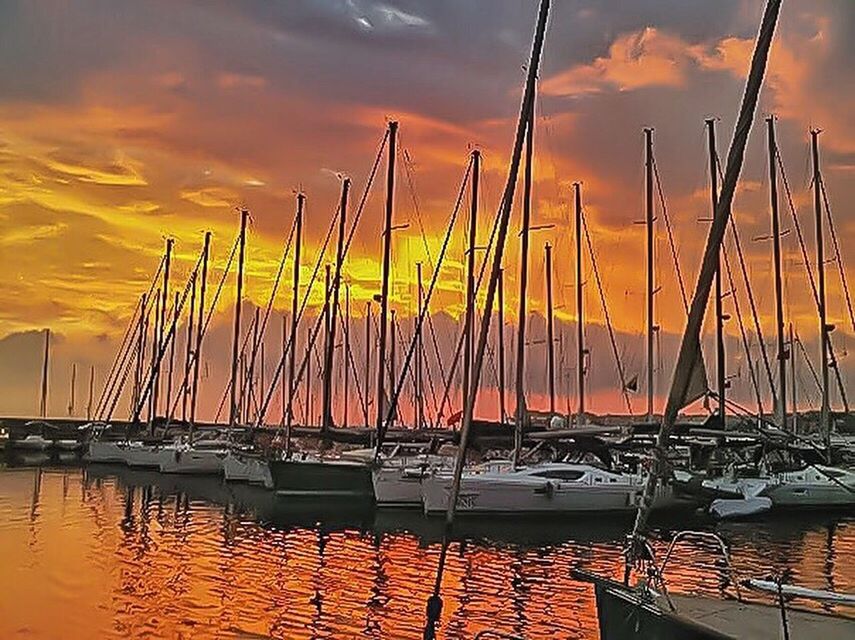 BOATS MOORED AT HARBOR