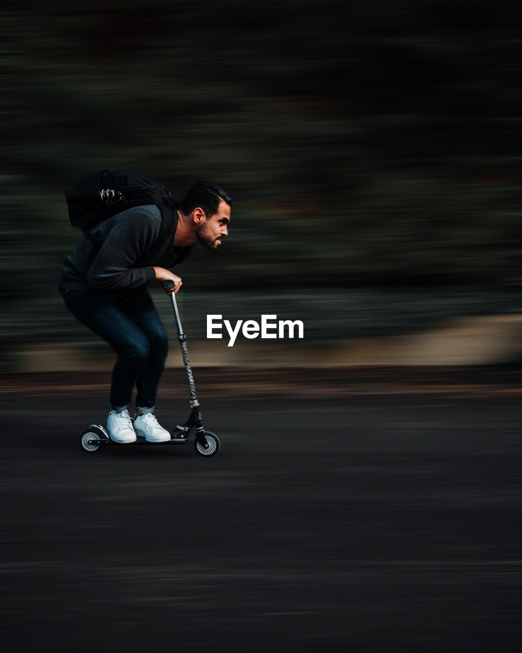 Full length of man on push scooter