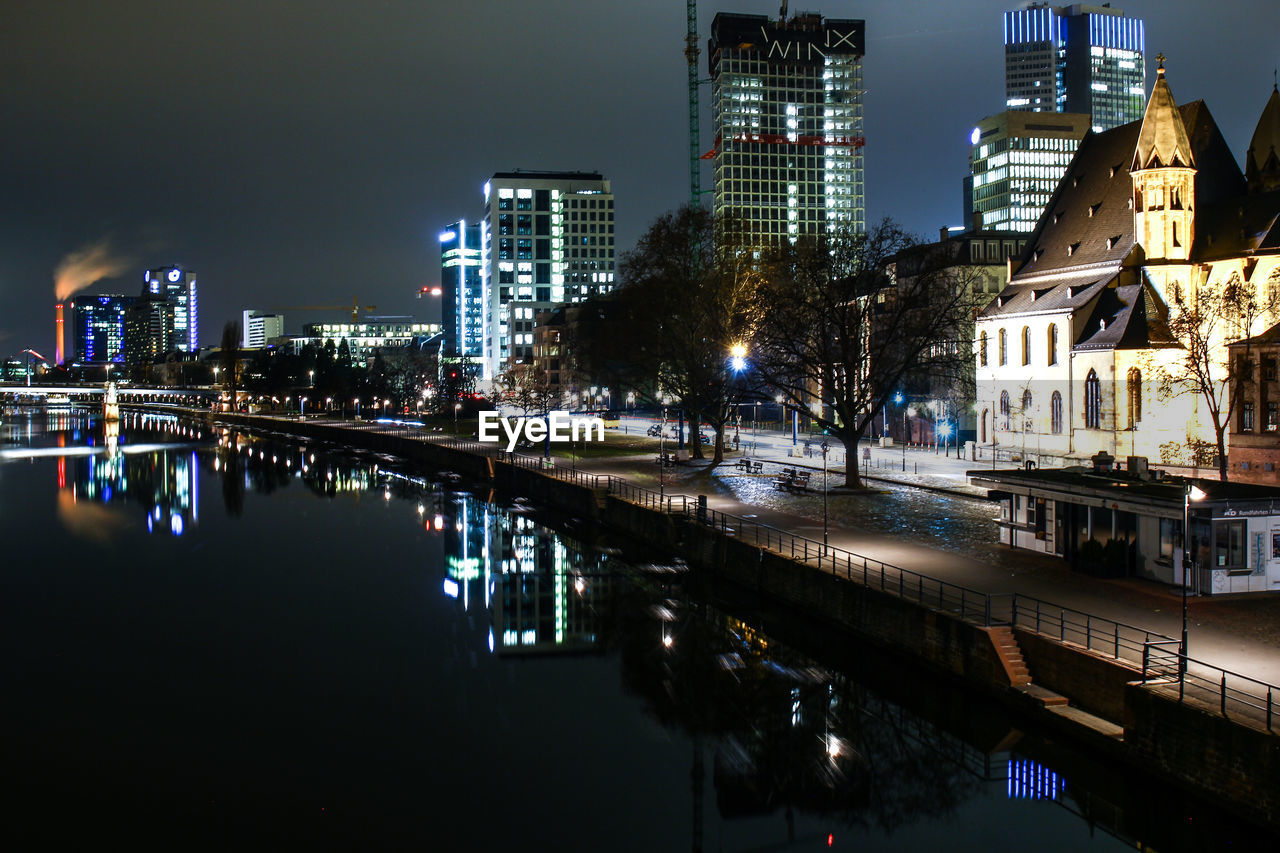 Reflection of buildings in city at night