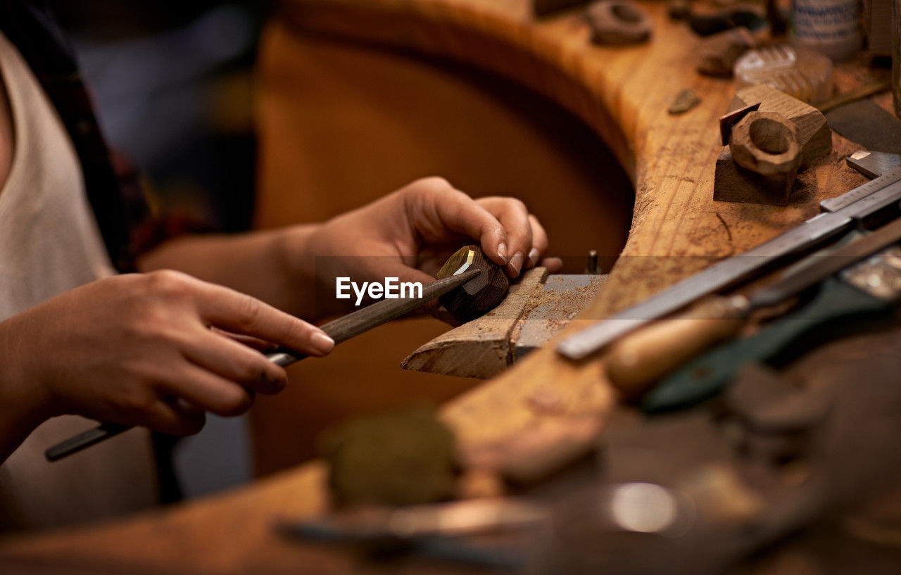 cropped hand of man working on table