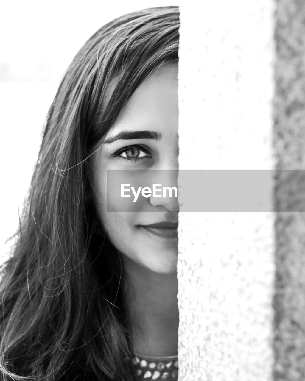 Close-up portrait of beautiful woman standing by wall