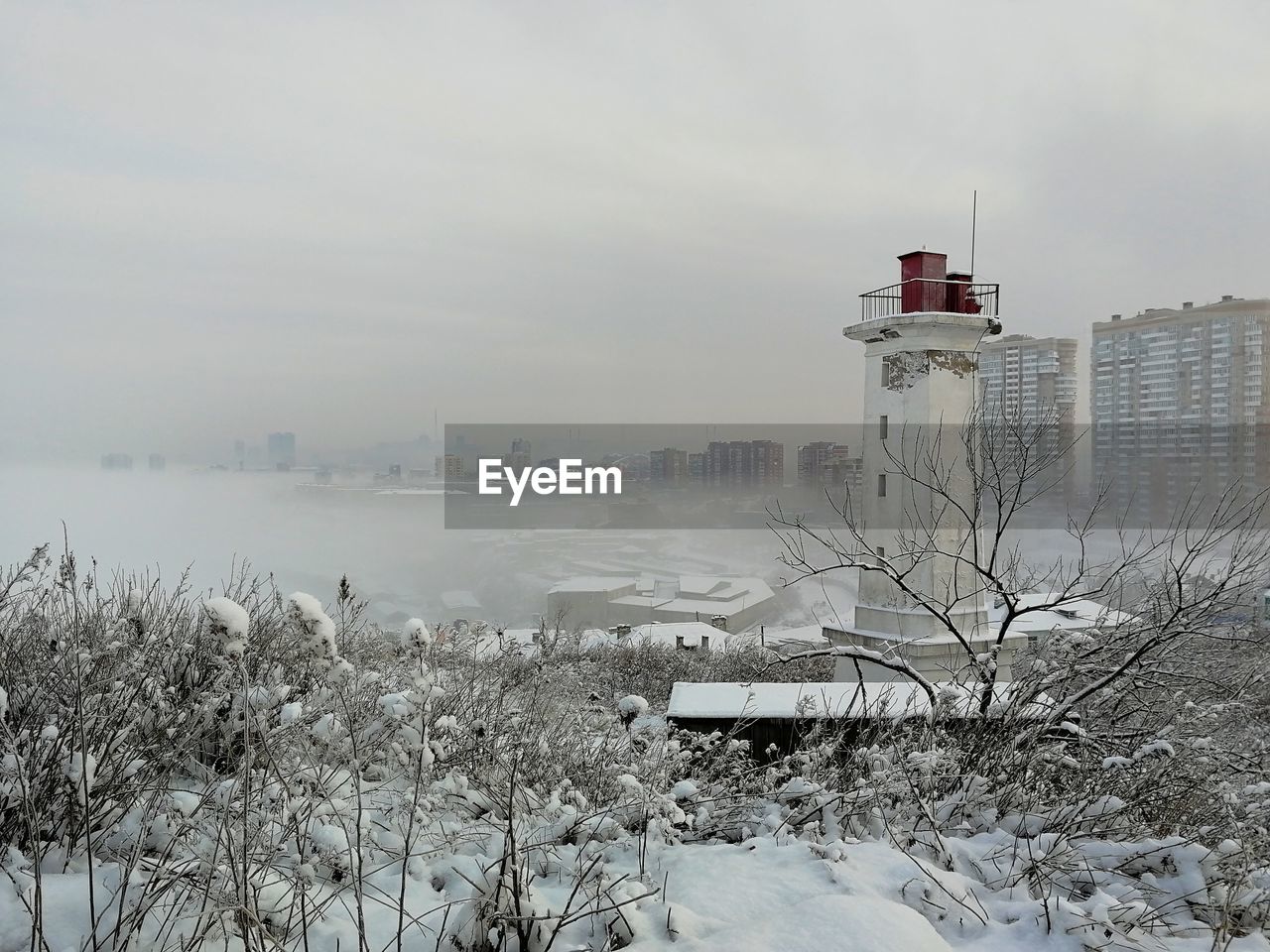 SNOW COVERED BUILDINGS AGAINST SKY