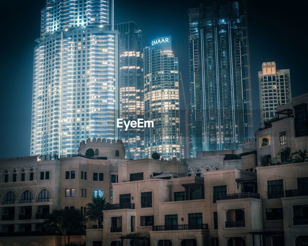 LOW ANGLE VIEW OF ILLUMINATED BUILDINGS AGAINST SKY