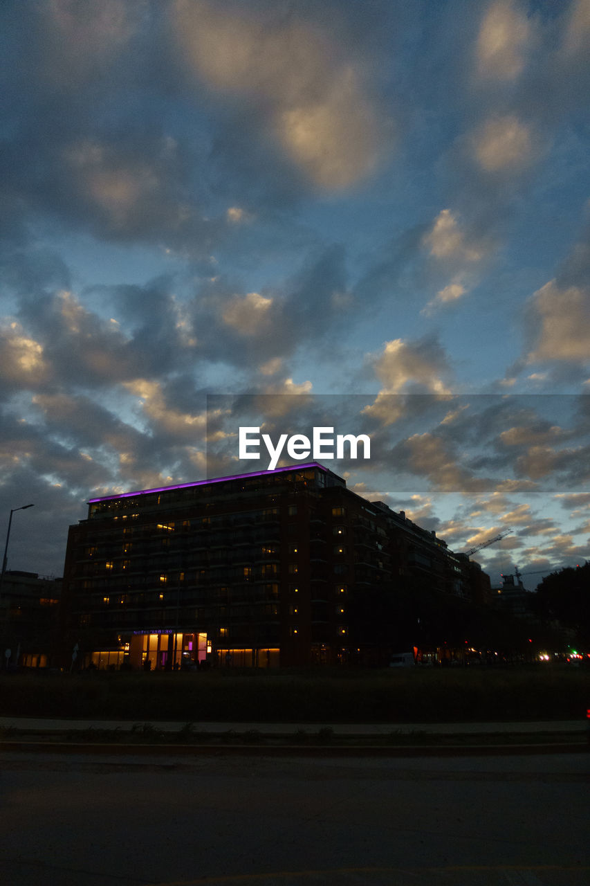 LOW ANGLE VIEW OF BUILDING AGAINST SKY AT SUNSET