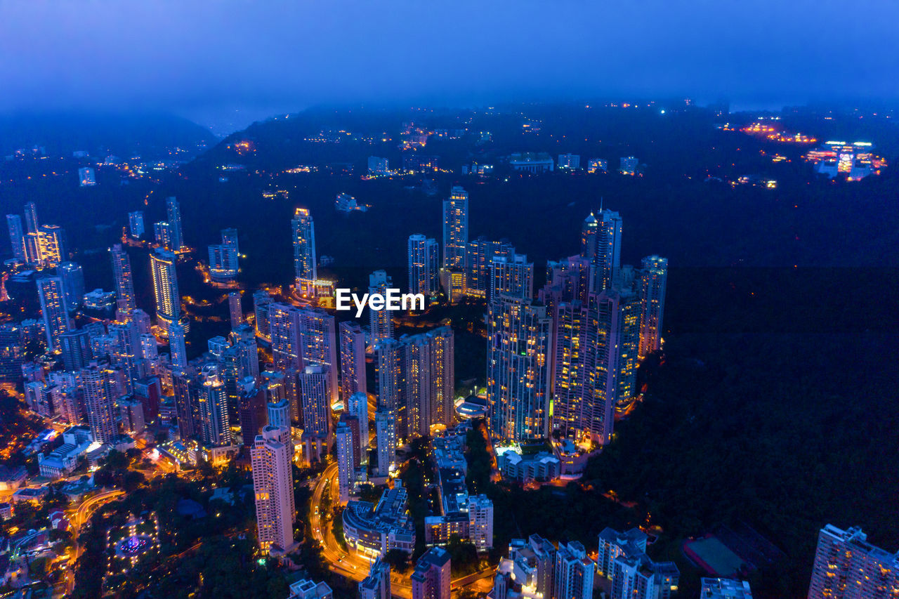 High angle view of illuminated modern buildings in city at night