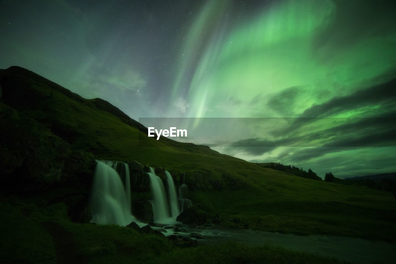 Scenic view of mountains against sky at night